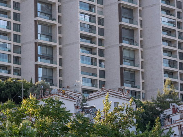 High-rise residential building facade with trees in Bornova, İzmir.
