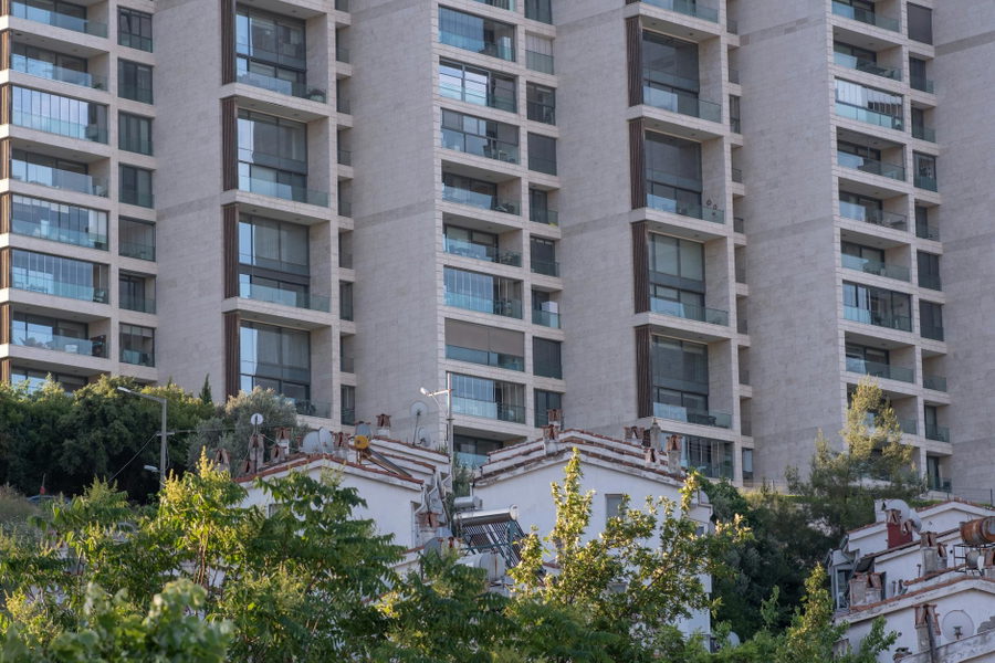 High-rise residential building facade with trees in Bornova, İzmir.