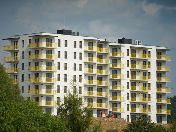 Photography of a modern apartment building with yellow balconies in Trzebinia, Poland