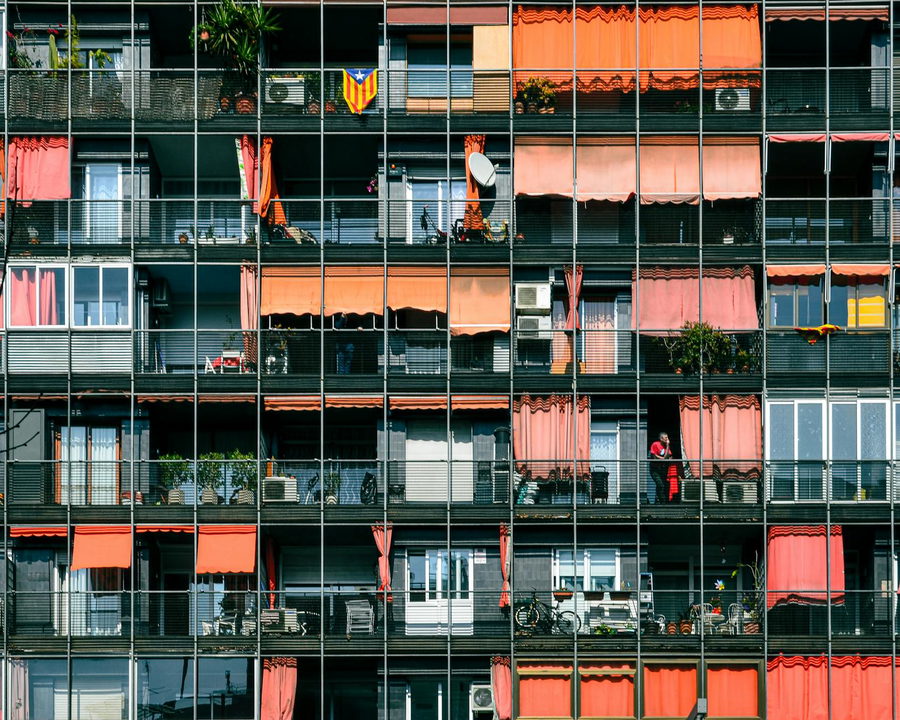A colorful and dynamic facade of modern apartments in Barcelona, Spain.