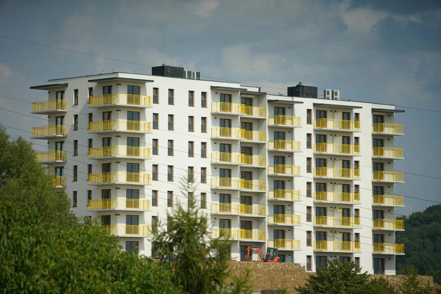 Photography of a modern apartment building with yellow balconies in Trzebinia, Poland