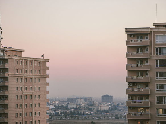 Scenic view of city skyline with high-rise buildings during a serene dusk.