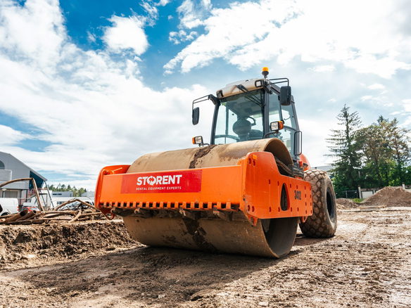 Large vibratory roller compactor on a sunny construction site in Keila, Estonia.